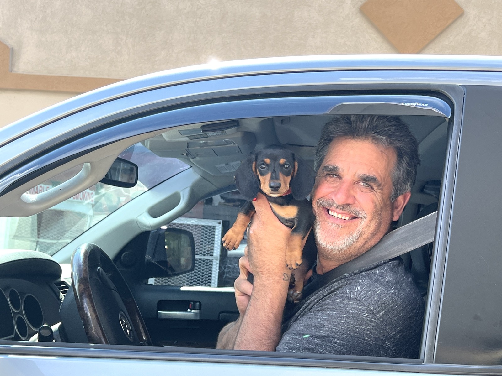 Brad, sitting in his truck with his dog